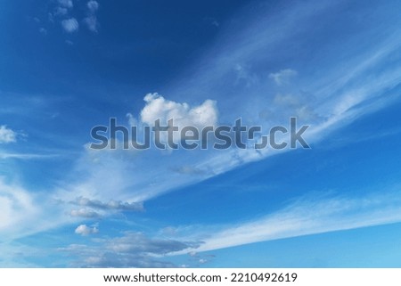 Cirrus and cumulus clouds in a blue sky.