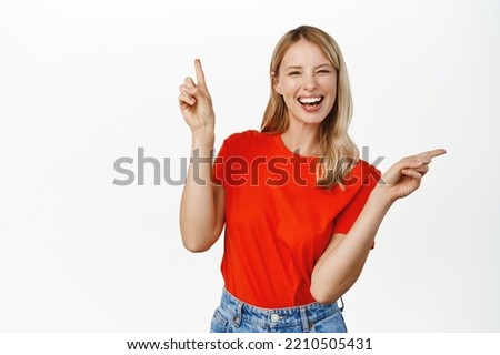 Choice, decision. Cute smiling blond girl pointing sideways, showing left and right, two ways, deciding, picking from variants, white background