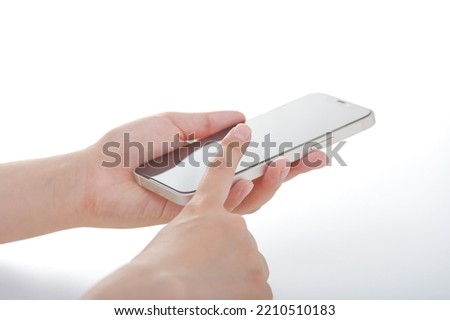 The hands of a Japanese woman operating a smartphone Royalty-Free Stock Photo #2210510183