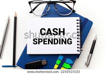 Cash Spending text written on notebook with pen and chart