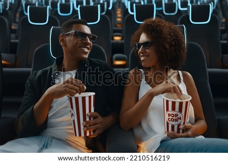 Couple watching movie with popcorn in cinema. High quality photo