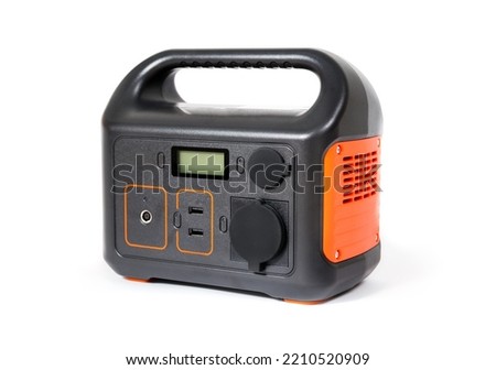 Isolated portable power station. Portable power supply battery to use for camping, fishing, hunting or during power outages. Selective focus. Royalty-Free Stock Photo #2210520909
