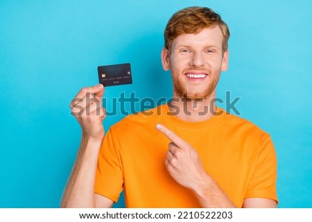 Photo of cute ginger hair guy index card wear orange t-shirt isolated on teal color background