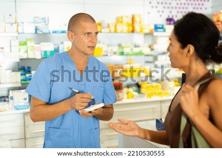 Buyer dictates the medicine to the pharmacist to write in a notebook