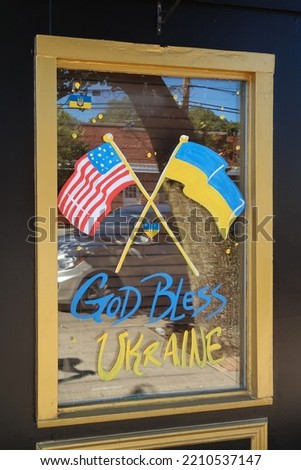 God bless Ukraine, painted on a storefront window.                                