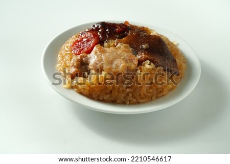 Lo Mai Gai - a traditional dim sum dish steamed brown glutinous rice with chicken, Chinese mushroom and sausages