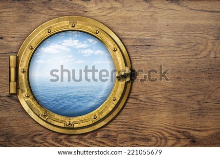 ship porthole on wooden wall Royalty-Free Stock Photo #221055679