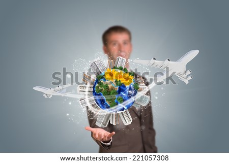 Businessman holding earth with buildings. Element of this image furnished by NASA