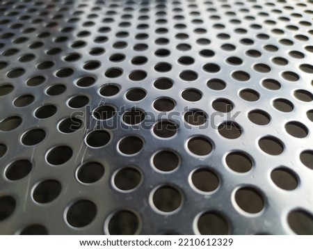 Close up photo of perforated metal for background