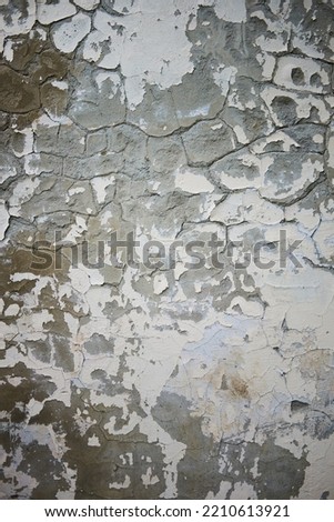 Background with peeling gray white wall. Vertical photo.
