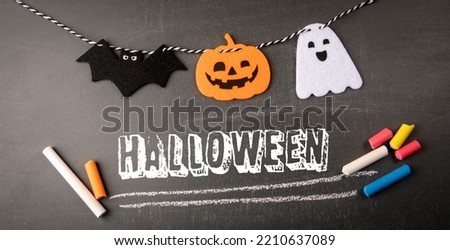 Halloween party concept. Text and decorations on a chalk board.