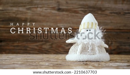 Composition of happy christmas text and santa claus on wooden background. Christmas, festivity, celebration and festivity concept digitally generated image.