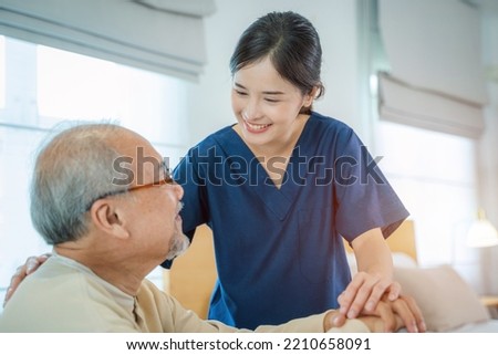 Caregiver hold hand of senior man patient give comfort,Express health care sympathy at nursing home,Concept senior people health care.