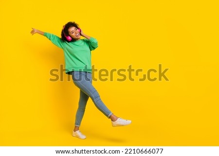Full body photo of peaceful chilling girl enjoy listen favorite song isolated on yellow color background