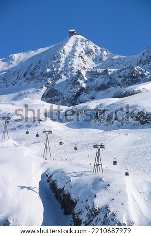 winter scene at the snowy ski resort of Alpe d'huez in Isere in France Royalty-Free Stock Photo #2210687979