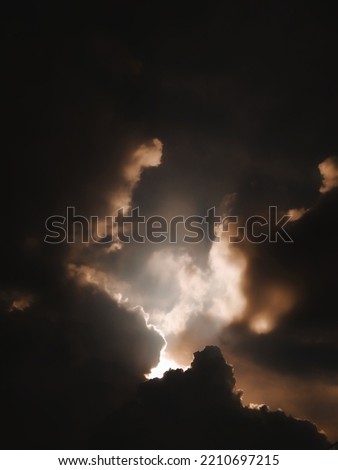 abstract photo of sunlight behind black clouds