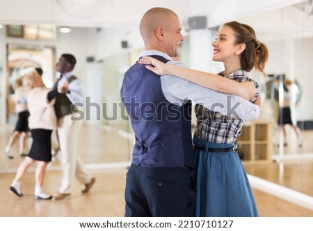 Happy man and woman enjoying ballroom dancing Royalty-Free Stock Photo #2210710127