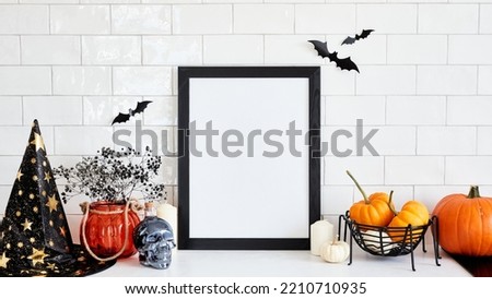 Spooky Halloween home interior with black picture frame, Halloween decorations, pumpkins. Happy Halloween poster mockup.