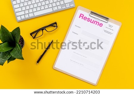 Searhing for a new job. Resume application form on office table