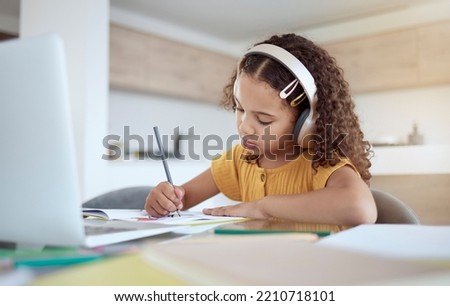 Children, education and writing with a girl student distance learning from home on a laptop for homework or study. Kids, book and school with a child at her desk to learn for growth and development