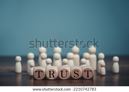 Wooden blocks with the word Trust,  Trust relationships between, reliable partner, business partners, confidence person, friends, relatives, respect and authority.  