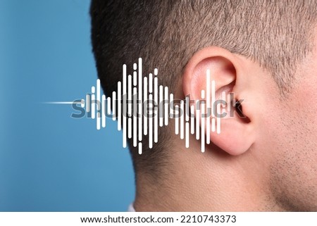 Hearing loss concept. Man and sound waves illustration on light blue background, closeup Royalty-Free Stock Photo #2210743373