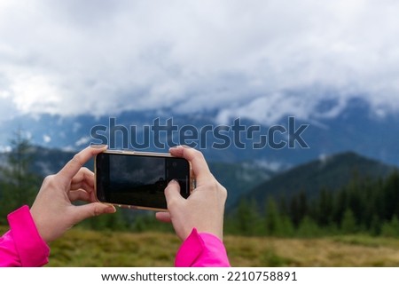 Person takes picture in the mountains.