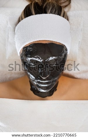Woman with alginate mask on face in beauty spa