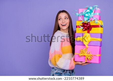 Photo of excited cheerful girl hold pile giftbox look interested empty space isolated on violet color background