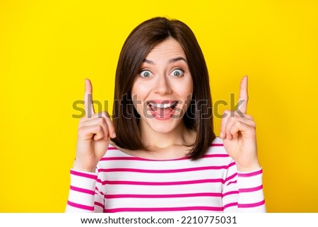 Closeup photo of young attractive woman directing fingers up click link advert isolated on yellow color background