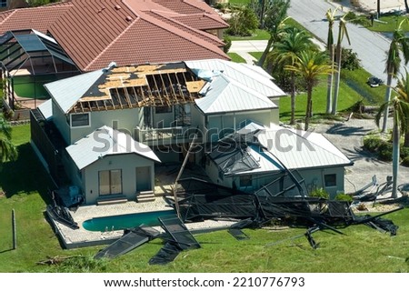 Hurricane Ian destroyed house in Florida residential area. Natural disaster and its consequences Royalty-Free Stock Photo #2210776793