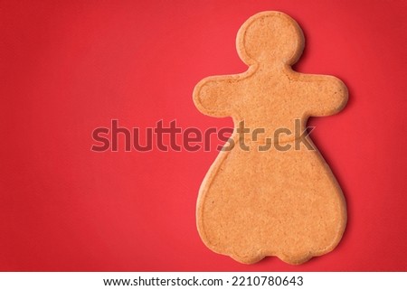 Gingerbread man sweet cookie on red background