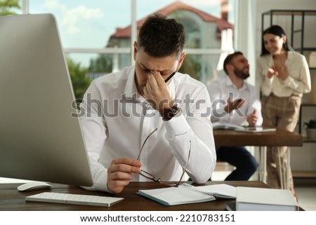 Man suffering from toxic environment at work Royalty-Free Stock Photo #2210783151
