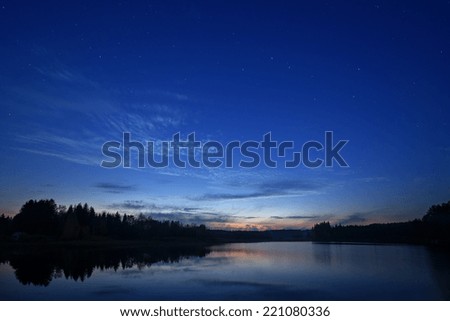 Starry night landscape near the lake