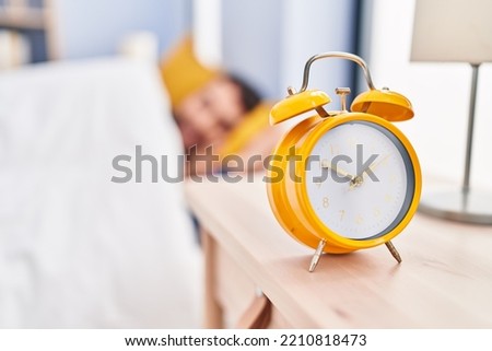 Young hispanic man sleeping on bed at bedroom