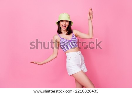 Portrait of young dancing funny lady wear cute cap mini shorts party summer chill disco drunk isolated on pink color background