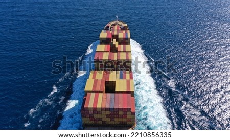 Aerial drone photo of colourful truck size container tanker ship cruising Mediterranean deep blue sea
