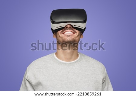 Virtual reality concept. Close-up studio portrait of smiling young man in VR glasses