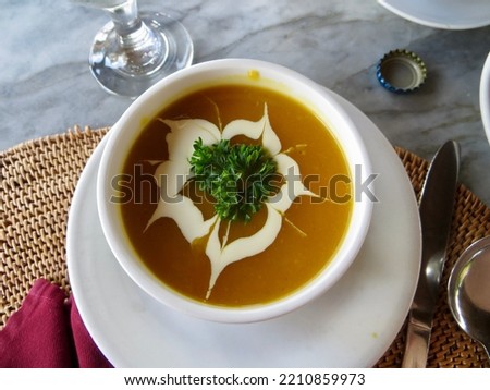 A delicious yellow soup with cream