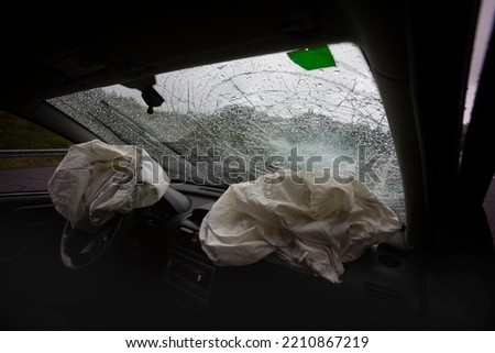 Two deflated Airbags in a car after a traffic accident Royalty-Free Stock Photo #2210867219