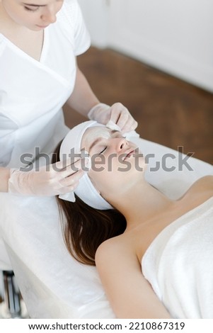 Close up of cosmetologist do beauty face procedures or treatment to woman client in aesthetic medicine clinic. Cosmetology concept. High quality photo