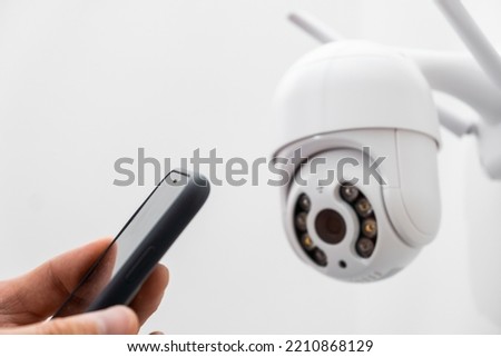 Installing and configuring an external surveillance camera using a phone. 