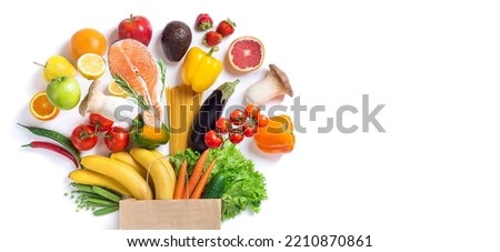 Healthy food background. Healthy food in paper bag fish, vegetables and fruits on white. Shopping food supermarket concept. Long format with copy space