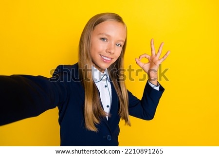 Photo of attractive positive girl arm demonstrates okey symbol recommend shopping low price sale isolated on yellow color background