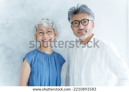 portrait of senior asian couple wearing eye glasses in the white room