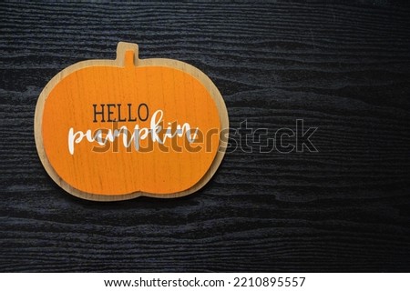 Hello Pumpkin flat lay, top down view, on a black wood background