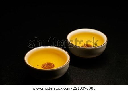 Traditional japanese, chinese asian tea ceremony concept. White ceramic tea cups with lotus on black background. Copy space.