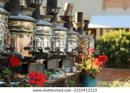 Tea urn semavers ordered nicely at garden. High quality photo