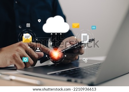 Network of cloud computing technology using laptops and smartphones Online devices upload information and data into a database with a business icon.