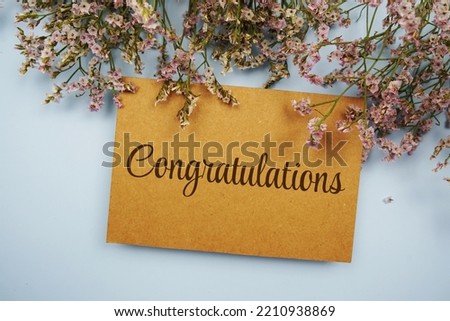 Congratulations typography text with flowers frame on blue background
